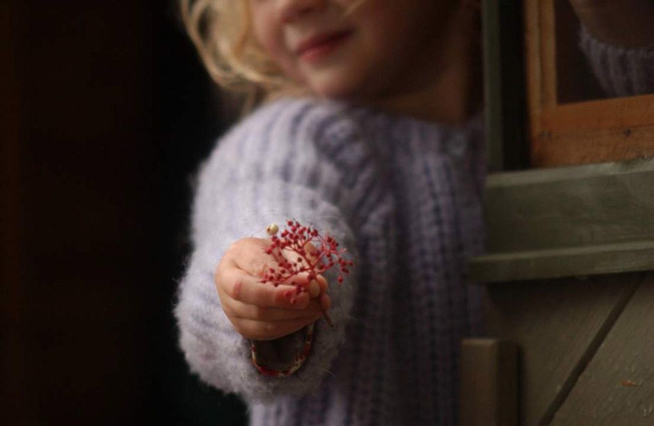 girl offering flowers photo